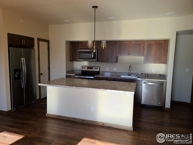 kitchen featuring a kitchen island, a sink, stainless steel appliances, dark wood-type flooring, and dark brown cabinetry