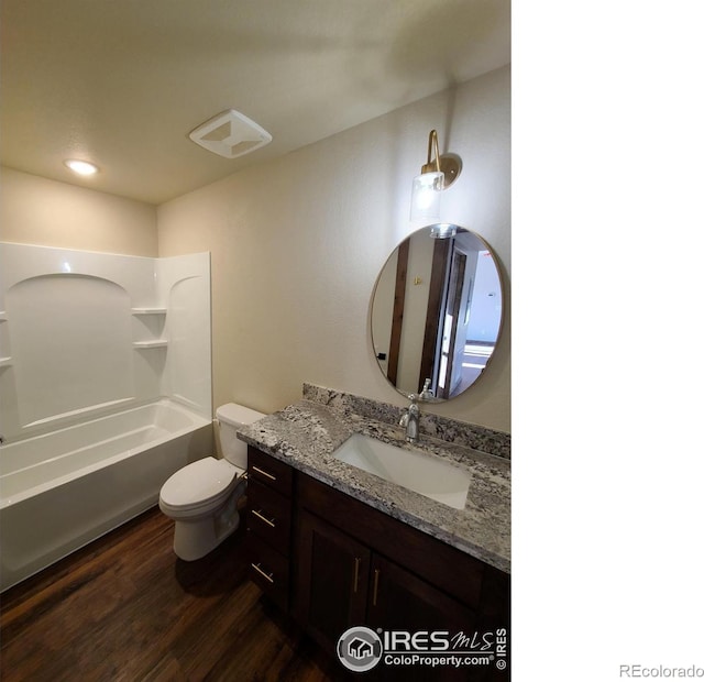 full bath featuring vanity, wood finished floors, recessed lighting, shower / tub combination, and toilet