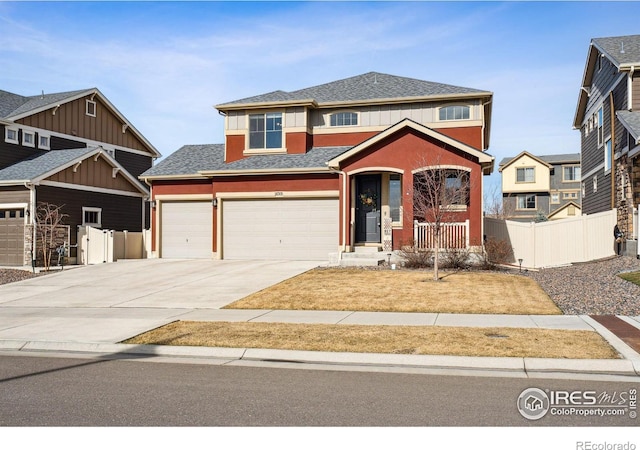 view of front of home featuring roof with shingles, concrete driveway, an attached garage, and fence