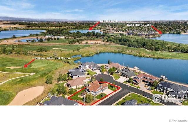 aerial view with a residential view, golf course view, and a water view