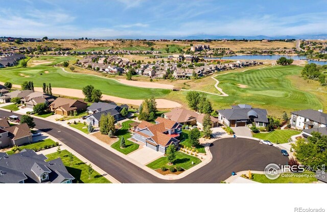 bird's eye view featuring view of golf course, a water view, and a residential view