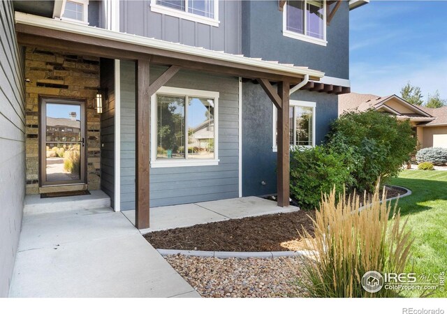 doorway to property featuring board and batten siding