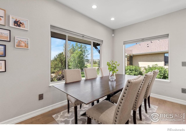 dining space featuring light wood-style flooring, recessed lighting, and baseboards