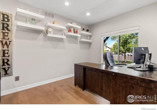 office space with recessed lighting, visible vents, baseboards, and light wood-style flooring