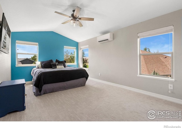 carpeted bedroom featuring multiple windows, an AC wall unit, baseboards, and vaulted ceiling