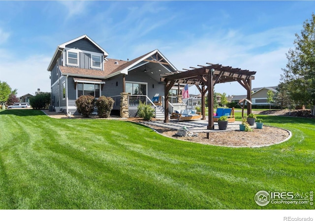 back of property featuring a yard, a pergola, and a patio