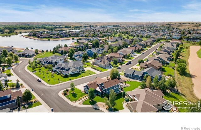 drone / aerial view featuring a residential view and a water view