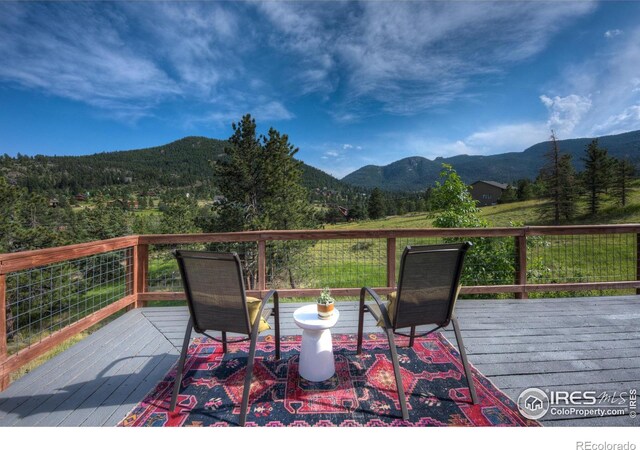 wooden terrace featuring a mountain view