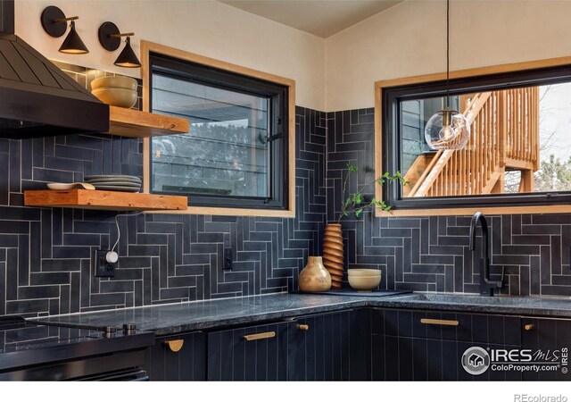 interior details featuring open shelves, backsplash, and exhaust hood