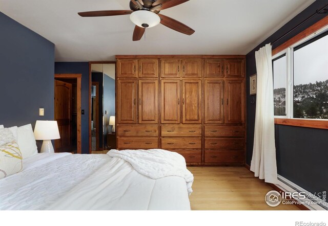 bedroom featuring light wood-style floors and a ceiling fan