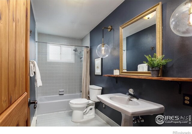 bathroom featuring tile patterned flooring, shower / bath combination with curtain, and toilet