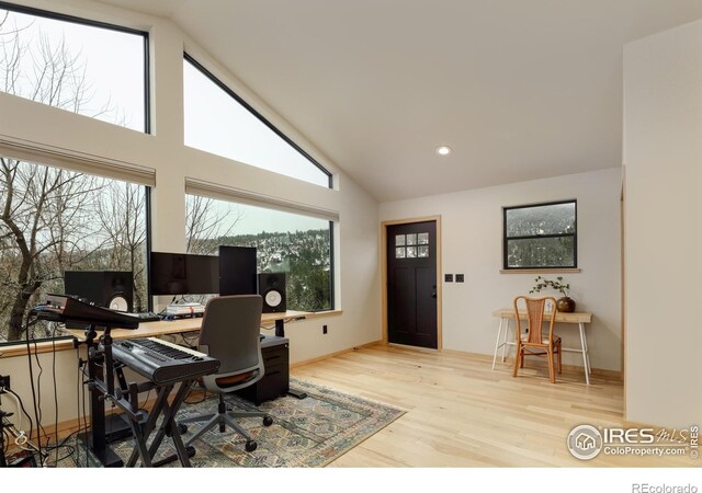 home office featuring recessed lighting, high vaulted ceiling, and wood finished floors