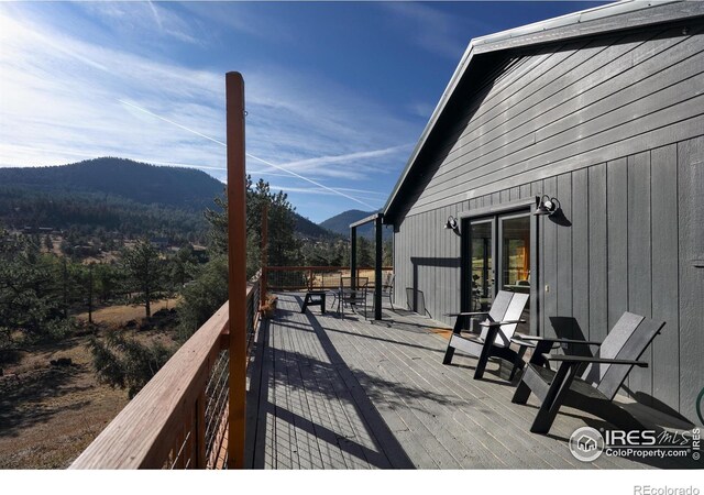 wooden deck with a mountain view