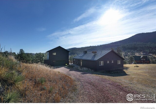 view of property exterior featuring an outbuilding and a mountain view