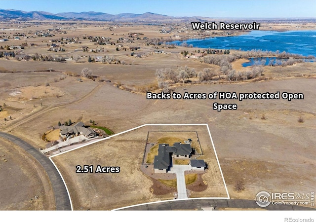 birds eye view of property featuring a mountain view