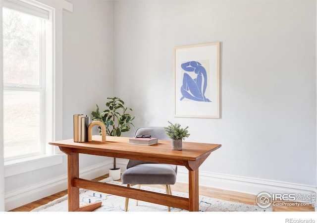 office area with baseboards and wood finished floors