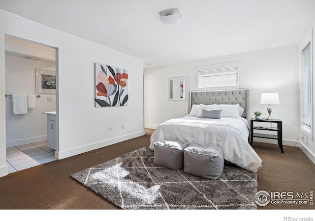 tiled bedroom with multiple windows, baseboards, connected bathroom, and carpet