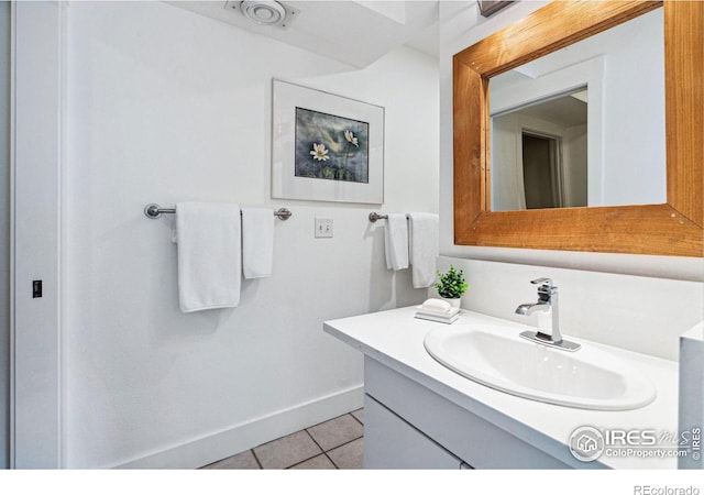 bathroom featuring tile patterned flooring, visible vents, vanity, and baseboards