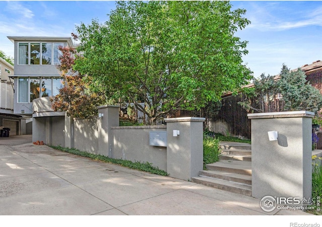 exterior space featuring a fenced front yard and stucco siding