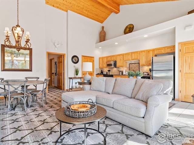 living room featuring a chandelier, beamed ceiling, and high vaulted ceiling