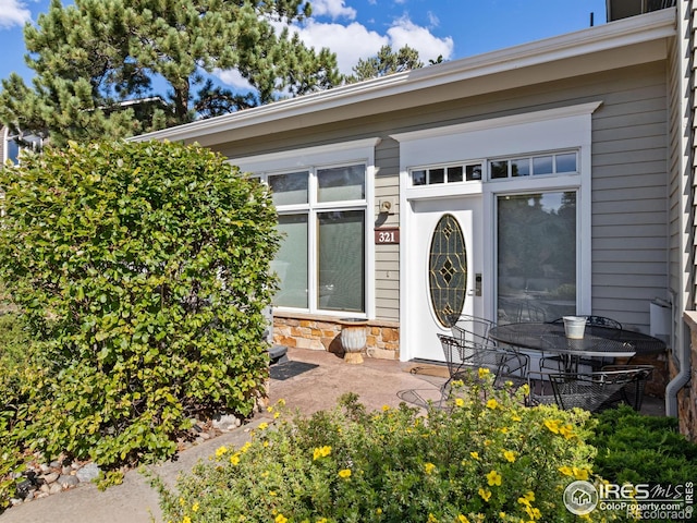 doorway to property with stone siding