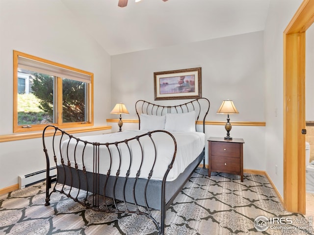 bedroom featuring lofted ceiling, baseboards, and baseboard heating