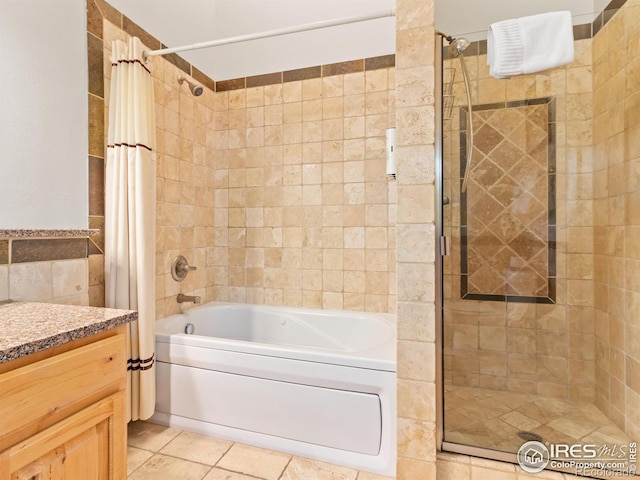 full bath featuring vanity, tile patterned floors, and tiled shower / bath