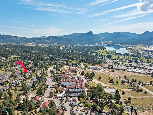 aerial view featuring a water and mountain view