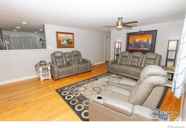 living area featuring recessed lighting, wood finished floors, and baseboards