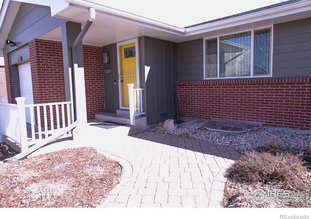 property entrance featuring brick siding