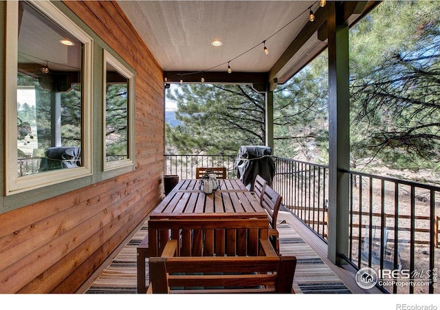 wooden terrace with outdoor dining space