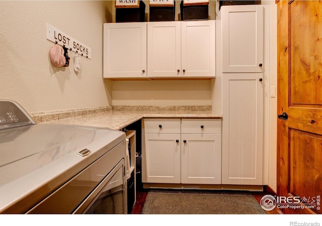 washroom with cabinet space and independent washer and dryer