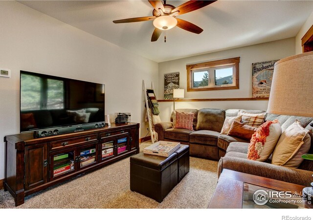 carpeted living room with ceiling fan