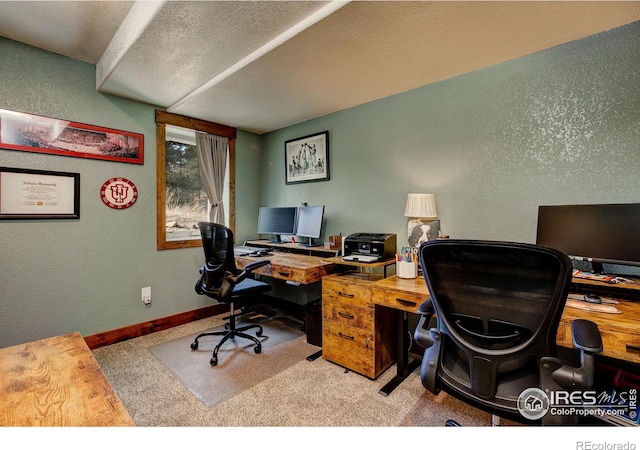 carpeted office featuring a textured ceiling, baseboards, and a textured wall