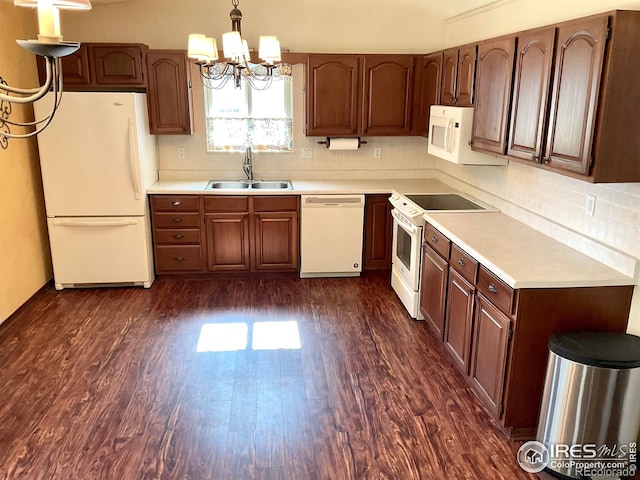 kitchen featuring a sink, white appliances, dark wood-style flooring, and light countertops