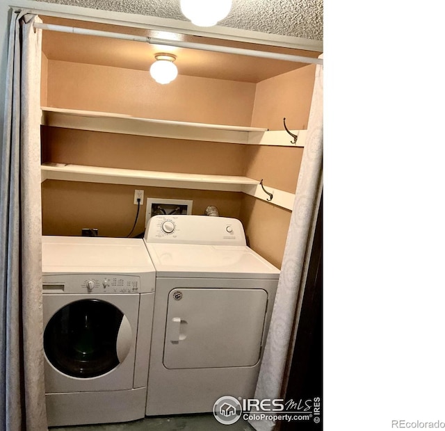 washroom with washer and clothes dryer and laundry area