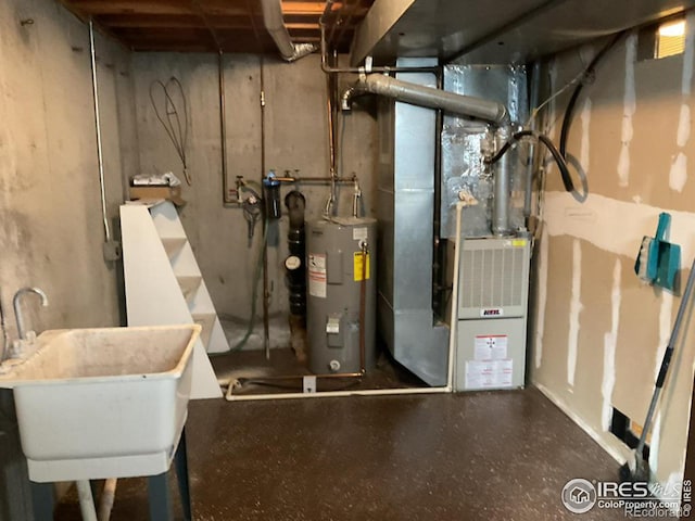 utilities featuring water heater, heating unit, and a sink