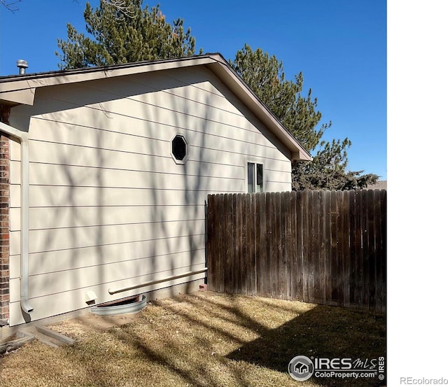 view of property exterior featuring fence