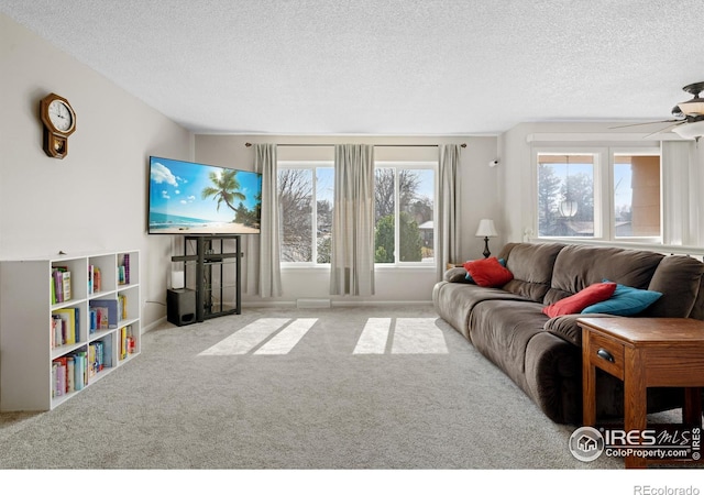 carpeted living room with a textured ceiling and a ceiling fan