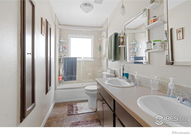 bathroom featuring double vanity, toilet, visible vents, and a sink