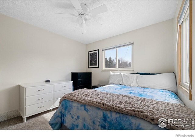 bedroom featuring visible vents, ceiling fan, a textured ceiling, and carpet