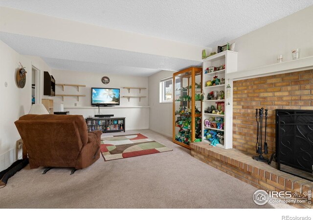 carpeted living area featuring a textured ceiling and a fireplace