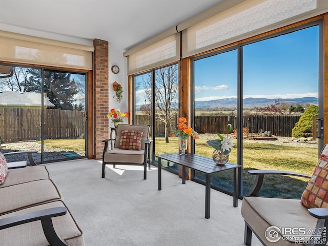 sunroom / solarium with a mountain view and a wealth of natural light