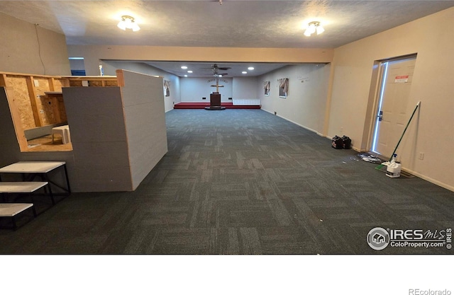 corridor with recessed lighting, carpet, baseboards, and a textured ceiling