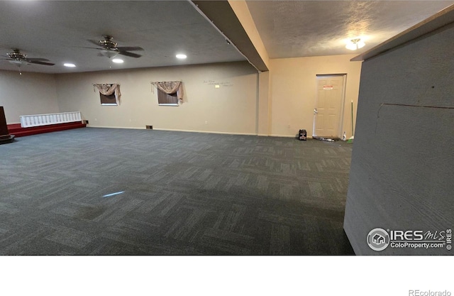 below grade area with recessed lighting, baseboards, carpet floors, and a ceiling fan