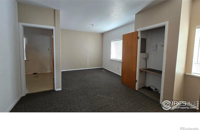 unfurnished bedroom with baseboards and carpet