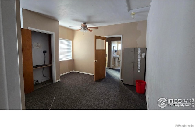 carpeted empty room featuring baseboards and ceiling fan