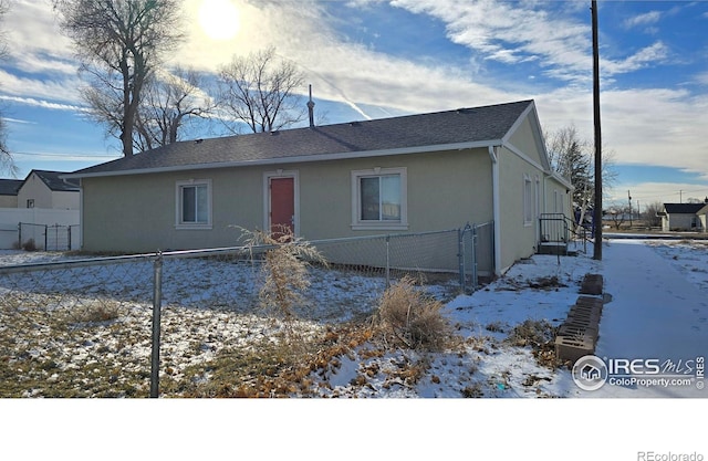 view of front of property with fence and stucco siding