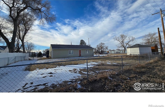 back of property with a fenced backyard and stucco siding