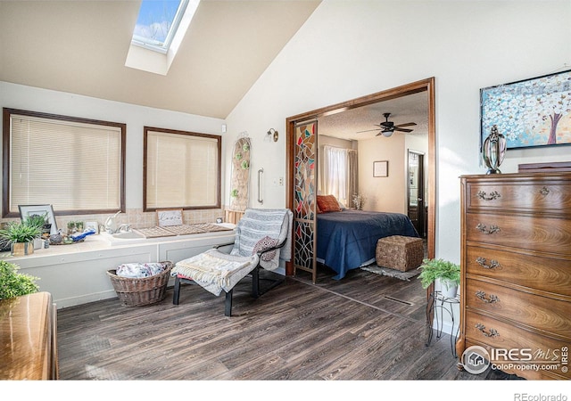 bedroom featuring vaulted ceiling with skylight, a ceiling fan, and dark wood-style flooring